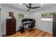 Bedroom with wood floors, a ceiling fan, two windows, and a desk at 1546 69Th S Pl, St Petersburg, FL 33705