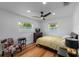 Bedroom featuring two windows, a ceiling fan, wood floors, and a chair at 1546 69Th S Pl, St Petersburg, FL 33705