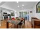 Open floor plan with view from dining area into kitchen, and sliding doors to outdoor pool at 1546 69Th S Pl, St Petersburg, FL 33705