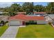 Aerial view of a single-Gathering home with an attached garage and a well-maintained front lawn at 1546 69Th S Pl, St Petersburg, FL 33705