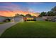 Charming single-story home featuring a well-manicured lawn, a red front door and sunset at 1546 69Th S Pl, St Petersburg, FL 33705