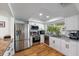 Modern kitchen featuring stainless steel appliances, a large window, and white cabinets at 1546 69Th S Pl, St Petersburg, FL 33705