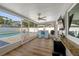 Bright lanai with ceiling fan, bar, and outdoor access overlooking the beautiful pool and backyard at 1546 69Th S Pl, St Petersburg, FL 33705