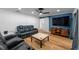 Living room featuring wood floors, a ceiling fan, and a TV at 1546 69Th S Pl, St Petersburg, FL 33705