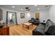 Living room featuring wood floors, a ceiling fan, black leather furniture, and a sliding glass door at 1546 69Th S Pl, St Petersburg, FL 33705