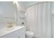 Bright and clean bathroom with white vanity, gold fixtures, and shower with white curtain at 1603 Scotch Pine Dr, Brandon, FL 33511