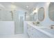 Modern bathroom featuring double vanity, gold fixtures, and a luxurious glass enclosed walk-in shower at 1603 Scotch Pine Dr, Brandon, FL 33511