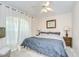 Cozy bedroom with a comfortable bed, soft carpet, and natural light from the window at 1603 Scotch Pine Dr, Brandon, FL 33511