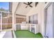 Outdoor kitchen with stainless steel grill and beverage cooler, set on a turf area for entertaining at 1603 Scotch Pine Dr, Brandon, FL 33511
