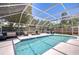 Sparkling screened-in pool surrounded by comfortable seating and lush landscaping at 1603 Scotch Pine Dr, Brandon, FL 33511