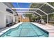 Sparkling screened-in pool and poolside area, offering the perfect setting for summer fun and relaxation at 1603 Scotch Pine Dr, Brandon, FL 33511
