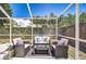 Comfortable screened patio with stylish seating, creating a relaxing outdoor lounge area at 1603 Scotch Pine Dr, Brandon, FL 33511