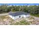 Aerial view of house with black roof and green landscaping at 16134 Libourn Ave, Port Charlotte, FL 33954