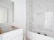 Bright bathroom under construction with a tub, shower with new tile, and a vanity cabinet at 16134 Libourn Ave, Port Charlotte, FL 33954