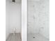 This in-progress bathroom has a tiled shower with a hexagon tile floor and marble-look tile walls at 16134 Libourn Ave, Port Charlotte, FL 33954