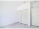 This bedroom features wood-look floors, and double door closet and a white interior door at 16134 Libourn Ave, Port Charlotte, FL 33954
