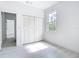 Light-filled bedroom with modern wood-look flooring, closet, fresh white paint, and a window at 16134 Libourn Ave, Port Charlotte, FL 33954
