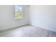 This bedroom features wood-look floors, large window and is ready for personal touches at 16134 Libourn Ave, Port Charlotte, FL 33954