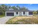 Newly constructed single-Gathering home with a modern black-and-white design and attached garage at 16134 Libourn Ave, Port Charlotte, FL 33954