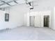 An empty two car garage with white walls and sealed concrete floor at 16134 Libourn Ave, Port Charlotte, FL 33954