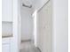 Bright hallway features closet and doorway with gray floors at 16134 Libourn Ave, Port Charlotte, FL 33954