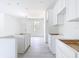 This in-progress bright kitchen features sleek white cabinets and modern, minimalist design at 16134 Libourn Ave, Port Charlotte, FL 33954