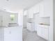 An in-progress bright kitchen showcases white cabinets, recessed lighting, and a clean, minimalist aesthetic at 16134 Libourn Ave, Port Charlotte, FL 33954
