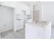 The bright kitchen is under construction, with white cabinets, an island frame, and laminate flooring at 16134 Libourn Ave, Port Charlotte, FL 33954