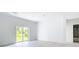 Bright living room with sliding glass doors to the back yard and light wood-look floors at 16134 Libourn Ave, Port Charlotte, FL 33954