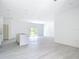 Bright open living space features recessed lighting, wood-look floors and sliding glass doors to the backyard at 16134 Libourn Ave, Port Charlotte, FL 33954