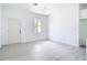 Bright living room featuring light wood-look flooring, fresh white paint and ample natural light at 16134 Libourn Ave, Port Charlotte, FL 33954