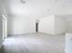 Spacious, bright living area with light-colored wood floors and fresh white walls, awaiting personalization at 16134 Libourn Ave, Port Charlotte, FL 33954