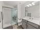 Modern bathroom with a glass-enclosed shower and neutral color palette at 17319 Holly Well Ave, Wimauma, FL 33598