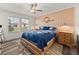 Relaxing bedroom with a coastal accent wall and natural light from the windows at 17319 Holly Well Ave, Wimauma, FL 33598