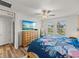 Bedroom featuring a view of the outdoors, neutral colors and a ceiling fan at 17319 Holly Well Ave, Wimauma, FL 33598