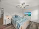 Cozy bedroom features white furniture, ceiling fan, and a TV for relaxation at 17319 Holly Well Ave, Wimauma, FL 33598