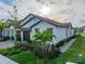 Charming single-story home with a tile roof, well-manicured landscaping, and a welcoming two-car garage at 17319 Holly Well Ave, Wimauma, FL 33598