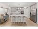 The kitchen features a central island with seating, pendant lighting, and modern stainless steel appliances at 17319 Holly Well Ave, Wimauma, FL 33598