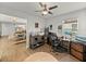 The office features a ceiling fan and offers a quiet workspace with natural light and tile flooring at 17319 Holly Well Ave, Wimauma, FL 33598