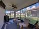 Screened-in patio with outdoor seating, ceiling fan, and neighborhood views at 17319 Holly Well Ave, Wimauma, FL 33598