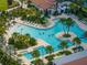 Enjoy this community pool featuring ample lounge seating, lush landscaping and clear blue water at 17319 Holly Well Ave, Wimauma, FL 33598