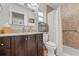 Bathroom with granite countertops, a dark wood vanity, and a shower with tile surround at 1880 Oak Bark Ct, Clearwater, FL 33763