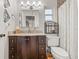 Bathroom with granite countertops, a dark wood vanity, and a shower with tile surround at 1880 Oak Bark Ct, Clearwater, FL 33763