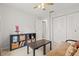 Bedroom with a futon, storage shelves, and bright lighting at 1880 Oak Bark Ct, Clearwater, FL 33763