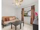 Bedroom with tile floors, a futon, and a window with natural light at 1880 Oak Bark Ct, Clearwater, FL 33763