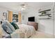 Bright bedroom featuring a ceiling fan, tile flooring, and a window with views at 1880 Oak Bark Ct, Clearwater, FL 33763