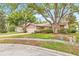 Charming single-story home with mature trees and vibrant landscaping at 1880 Oak Bark Ct, Clearwater, FL 33763
