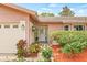 Up-close exterior showcasing a well-kept landscape and a beautiful front door at 1880 Oak Bark Ct, Clearwater, FL 33763