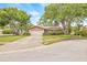 Inviting single-story home with a spacious driveway and a mature shade tree at 1880 Oak Bark Ct, Clearwater, FL 33763