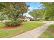 Landscaped front yard with mature trees enhancing the curb appeal at 1880 Oak Bark Ct, Clearwater, FL 33763